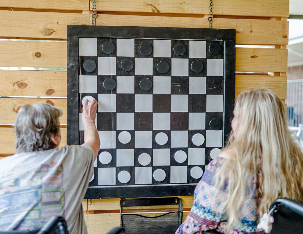 Two residents at Chambers, a skilled nursing facility, engage in a game of checkers