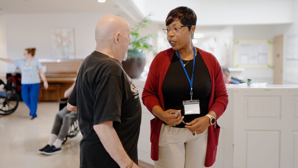 A staff member at Chambers speaks to a family member of a resident at the skilled nursing facility