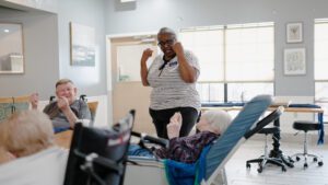 A nurse engages residents in an activity at a skilled nursing nursing home